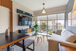 a living room with a couch and a table at Perricholi Central Apartments by Geko in Lima +35 photos