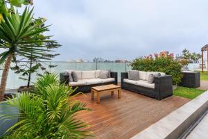 a patio with two couches and a coffee table at Perricholi Central Apartments by Geko in Lima