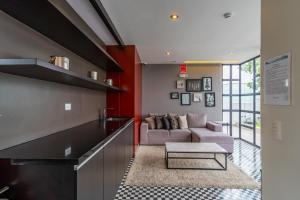 a living room with a couch and a table at Perricholi Central Apartments by Geko in Lima