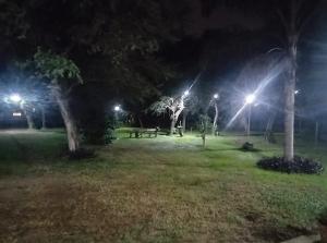 a park at night with lights in the grass at Finca LA Soñada in Santiago del Estero