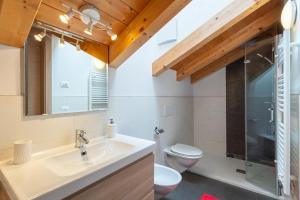 a bathroom with a sink and a toilet at Apartments Irene in La Villa +26 photos