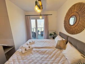 ein Schlafzimmer mit einem großen Bett und einem Spiegel an der Wand in der Unterkunft Apartamenty Złote Wydmy - Plażowa Park Międzywodzie in Międzywodzie