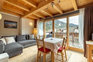 a living room with a table and a couch at Apartments Irene in La Villa