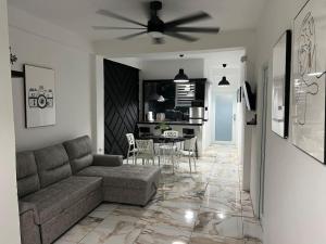 a living room with a couch and a table at VSS Minimalista in Arecibo - Sleek and Serene Stay Near Beaches in Arecibo