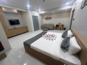 a bedroom with a large bed with a cake on it at Hotel Bhavans Elite in Rajiv Gandhi International Airport
