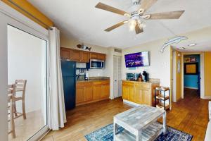 a kitchen with a ceiling fan and a blue refrigerator at Belleair Beach Club 312 in Clearwater Beach