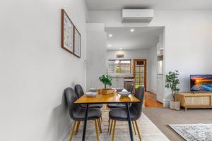 a dining room with a table and chairs at Cosy 2 bedroom house in Melbourne