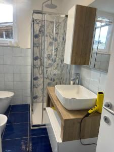 a bathroom with a sink and a shower at MAGA House in Pontecagnano