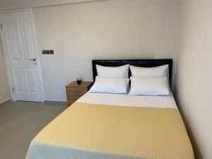 a bedroom with a bed with two white pillows at Ekin Assos in Ayvacık