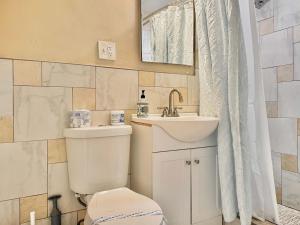 a bathroom with a toilet and a sink and a mirror at Downtown! 2BD City view Onsite Parking King LM809 in Atlanta