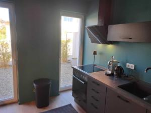 a kitchen with a sink and a stove top oven at Ferienwohnung Winter in Wasserburg