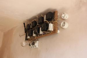a bunch of pots and pans hanging on a wall at Casa Nachiro - 16th Century Oil Mill Historic Dimora in Nardò