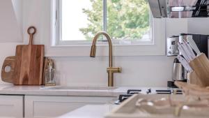 a kitchen counter with a sink and a window at The Ocean Loft At Kings in Cape May +30 photos