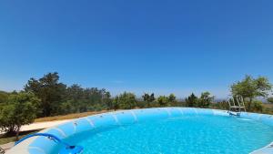 a large swimming pool with a water slide at Monte da Silveira in São Teotónio