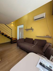 a living room with a couch and a fan at Auto Tana Guest House in Tirana +46 photos