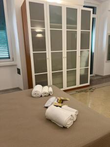 a room with a bed with towels and a cabinet at Cadorna 30 Guest House in Monopoli +32 photos