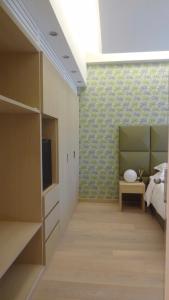 a bedroom with a bed and a tv in a room at Augustana House and Suites in Rome