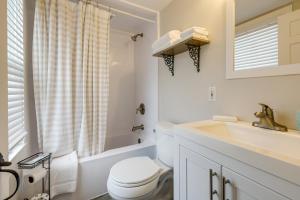 a white bathroom with a toilet and a sink at 1 Mi to Ferry Sea Street Cottage in Hyannis in Hyannis