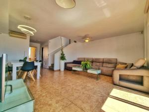 a living room with a couch and a table at Dúplex ENCANTOS DEL CABO, Retamar, Cabo de Gata in Retamar