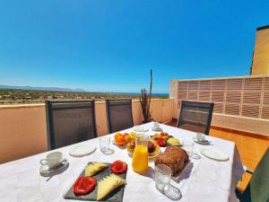 a table with a plate of food on a balcony at Dúplex ENCANTOS DEL CABO, Retamar, Cabo de Gata in Retamar +22 photos