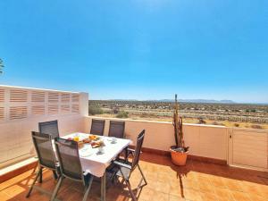 a dining room with a table and chairs on a balcony at Dúplex ENCANTOS DEL CABO, Retamar, Cabo de Gata in Retamar