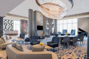 a lobby with couches and tables and a chandelier at Crowne Plaza Lucknow by IHG in Lucknow