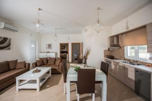 a kitchen and living room with a couch and a table at Lila Villas in Stalos