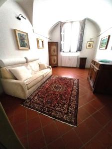 a living room with a couch and a rug at Dal Teatro - Imola Centro in Imola