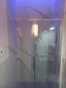 a bathroom with a shower with a glass door at Dal Teatro - Imola Centro in Imola