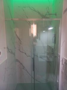 a shower with a glass door in a bathroom at Dal Teatro - Imola Centro in Imola
