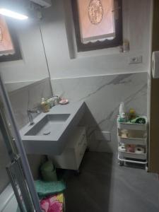 a small bathroom with a sink and a mirror at Dal Teatro - Imola Centro in Imola