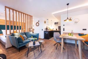a living room with a couch and a table at Apartment Pica in Bad Elster