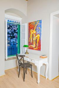 a white desk in a room with a painting on the wall at "LOS" 1 Neoclassic Harbour View in Symi
