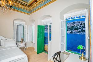 a bedroom with a bed and a large window at "LOS" 1 Neoclassic Harbour View in Symi +25 photos
