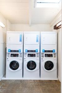 four washers and dryers in a laundry room at Camp Trinidad RV Resort in Trinidad