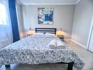 a bedroom with a bed with a comforter and pillows at Downtown Central Residences in Montréal