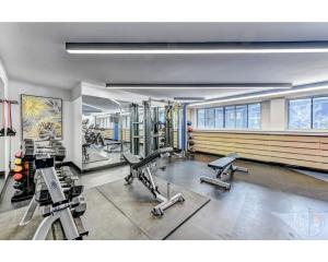 a gym with several treadmills and machines in it at Downtown Central Residences in Montréal