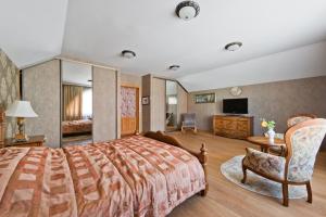 a hotel room with a bed and a television at Adelės Vila in Palanga