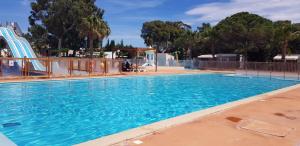 a large swimming pool with a roller coaster at camping la palmeraie chez caro et gui in Torreilles