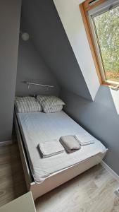 Una cama o camas en una habitación de Domek na Kaszubach - Brzozowy Raj Kaszubska Ostoja