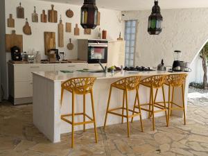 a kitchen with two bar stools and a counter at Villa Hirondelles 35 in Cavalaire-sur-Mer