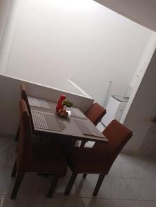 a toy bear sitting on a table with chairs at Casa para temporada no São João in Campina Grande