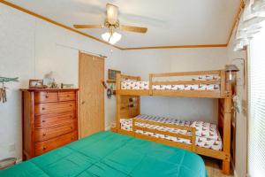 a bedroom with two bunk beds and a ceiling fan at Tallman Lake Access Family-Friendly Home with Dock! in Fountain