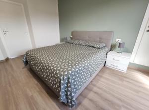 a bedroom with a bed with a gray comforter at Dimora alla pesa in Tuscany in Barberino di Mugello +2 photos