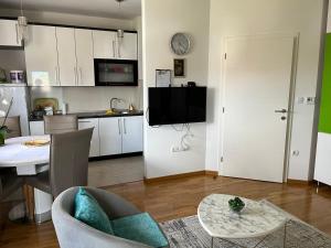 a living room with a kitchen and a dining room at Relax Teslić in Teslić
