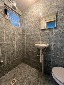 a bathroom with a sink and a toilet at Casa 89 in Diamantina +15 photos
