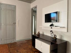 a living room with a television on a wall at Casa 89 in Diamantina
