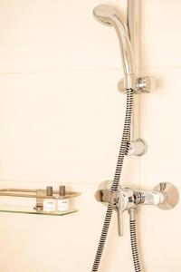a shower head hanging on a bathroom wall at Ferienwohnung Kunterbunt Eckernförde in Eckernförde