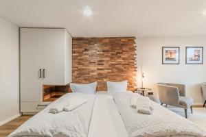 a bedroom with a large white bed with two pillows at Hotel Seepferdchen Zimmer 2 Eckernförde Self-Check-in in Eckernförde