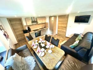 a living room with a table and a couch at Ferienhaus Krallinger in Abtenau